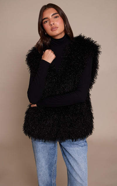 https://cdn-img.prettylittlething.com/3/a/a/a/3aaa2a60d4290cfe7a8143f9a5616f109770b995_CNO0272_1_black_mongolian_faux_fur_gilet.jpg